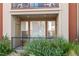 Private patio with a metal fence and lush greenery at 14321 E Tennessee Ave # 1-105, Aurora, CO 80012