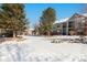 Residential building with snow-covered landscaping, showcasing a charming community setting at 10807 W Dartmouth Ave, Lakewood, CO 80227