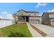 Two-story house with gray siding, stone accents, and a two-car garage at 1916 S Coolidge Way, Aurora, CO 80018