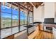 Gourmet kitchen with farmhouse sink, stainless steel appliances, and expansive windows at 964 Alpensee Dr, Breckenridge, CO 80424