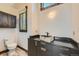 Bathroom with petrified wood sink and dark vanity at 964 Alpensee Dr, Breckenridge, CO 80424