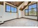 Bright bedroom with vaulted ceiling, large windows, and mountain views at 964 Alpensee Dr, Breckenridge, CO 80424