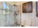 Bathroom with a glass-enclosed shower and wood cabinets at 964 Alpensee Dr, Breckenridge, CO 80424