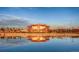 Community building with lake reflection, showcasing stunning architecture at 676 Apex Rise St, Erie, CO 80516