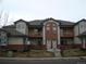 Front exterior view of a two-story condo building with balconies and attached garages at 11041 Huron St # 706, Northglenn, CO 80234