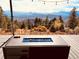 Deck with fire pit offering scenic mountain views at 13640 Old Paint Trl, Conifer, CO 80433