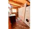 Clean bathroom with shower, toilet, and stackable washer/dryer at 13640 Old Paint Trl, Conifer, CO 80433