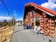 Log cabin home with deck, mountain views, and string lights at 13640 Old Paint Trl, Conifer, CO 80433
