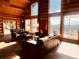 Living room with wood-burning stove and mountain views at 13640 Old Paint Trl, Conifer, CO 80433