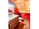 Small bathroom with red log cabin walls and gray vanity at 13640 Old Paint Trl, Conifer, CO 80433