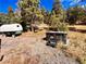 Hot tub nestled in a wooded backyard setting at 13640 Old Paint Trl, Conifer, CO 80433