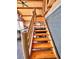 Wooden staircase leading to the upper level of the home at 13640 Old Paint Trl, Conifer, CO 80433