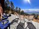 Deck with seating area and fire pit overlooking mountain views at 13640 Old Paint Trl, Conifer, CO 80433