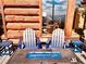 Relaxing patio with fire pit and blue Adirondack chairs at 13640 Old Paint Trl, Conifer, CO 80433