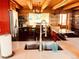 Rustic kitchen with exposed beams, farmhouse sink, and wood accents at 13640 Old Paint Trl, Conifer, CO 80433
