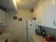 Small kitchen with white cabinets and appliances at 8060 E Girard Ave # 711, Denver, CO 80231