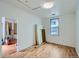 Simple bedroom with hardwood floors and large window at 13305 W 82Nd Ave, Arvada, CO 80005