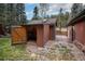 Exterior shed with open door, showing storage space inside at 28532 Shadow Mountain Dr, Conifer, CO 80433