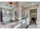 Elegant bathroom featuring dual vanities, granite countertops, and a walk-in shower at 1242 Sugarloaf Ln, Erie, CO 80516