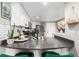 Kitchen with gray countertops and breakfast bar at 100 Park Ave # 204, Denver, CO 80205