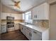 Galley kitchen with white cabinets, quartz countertops, and stainless steel appliances at 8465 Wheatgrass Cir, Parker, CO 80134