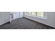 Bright bedroom with grey carpet and an ensuite bathroom at 8465 Wheatgrass Cir, Parker, CO 80134