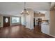 Open concept living and kitchen area with laminate flooring and a chandelier at 8465 Wheatgrass Cir, Parker, CO 80134