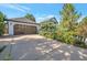 Attached garage with a wooden door and a spacious driveway at 8465 Wheatgrass Cir, Parker, CO 80134