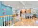View of kitchen, stairway, and living area with hardwood floors at 7193 S Versailles Way, Aurora, CO 80016