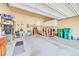 Organized garage with storage racks and a workspace at 7193 S Versailles Way, Aurora, CO 80016
