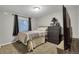 Cozy bedroom with a full-size bed and a dresser at 11384 Oakland Dr, Commerce City, CO 80640