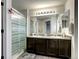 Bathroom with double vanity and glass shower at 4197 Deer Watch Dr, Castle Rock, CO 80104