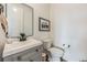 Modern powder room with gray vanity and black accents at 3839 Buchanan Way, Aurora, CO 80019