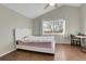 Bedroom with wood floors, white bed, and window with natural light at 4453 S Fundy St, Centennial, CO 80015