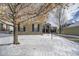 Brick home with snowy front yard and mature tree at 1390 Peninsula Cir, Castle Rock, CO 80104