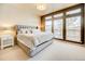 Spacious main bedroom with large windows and plush bedding at 1390 Peninsula Cir, Castle Rock, CO 80104