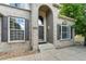 Brick front of two-story house with double door entry at 1390 Peninsula Cir, Castle Rock, CO 80104