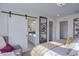 Main bedroom with ensuite bathroom and sliding barn door at 1165 Sugarloaf Ln, Erie, CO 80516