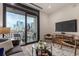 Living room with city view, balcony access, and mid-century modern furniture at 1901 Wazee St # 719, Denver, CO 80202