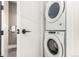 Modern laundry room with stacked washer and dryer at 1901 Wazee St # 719, Denver, CO 80202