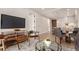 Living room with city view, balcony access, and mid-century modern furniture at 1901 Wazee St # 719, Denver, CO 80202