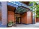 Modern building exterior with glass canopy and brick accents at 1901 Wazee St # 719, Denver, CO 80202