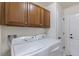 Laundry room with washer, dryer, and upper cabinets at 9332 Sori Ln, Highlands Ranch, CO 80126