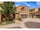 Townhouse exterior with two-car garage and landscaped entry at 9332 Sori Ln, Highlands Ranch, CO 80126