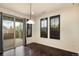 Dining room with hardwood floors and sliding glass door leading to a balcony at 9332 Sori Ln, Highlands Ranch, CO 80126