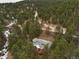 House with red deck nestled in a mountainside neighborhood at 11 Granite Dr, Boulder, CO 80302