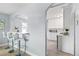 Kitchen with breakfast bar, white cabinets, and view into dining area at 4424 Decatur St, Denver, CO 80211