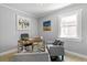 Home office features a wood desk, comfortable chairs, and large wall art at 4424 Decatur St, Denver, CO 80211