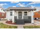 Charming brick home with a gray porch and landscaping at 4424 Decatur St, Denver, CO 80211