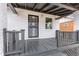 Inviting front porch with a gray deck and railings at 4424 Decatur St, Denver, CO 80211